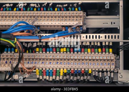 Detailed view of a high-tech electrical panel showcasing colorful wiring and connections. This image emphasizes the organization and complexity of mod Stock Photo