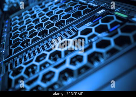 This image features a modern server array with a unique hexagonal design. The blue lighting accentuates the intricate components, highlighting the tec Stock Photo
