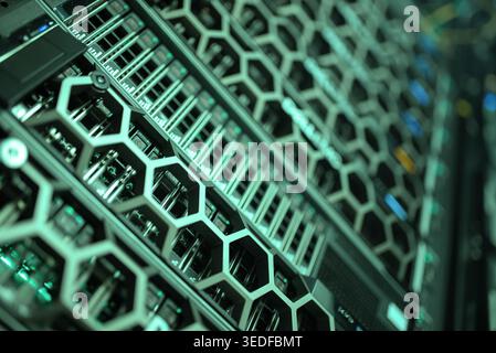 Close-up view of a modern server rack showcasing intricate hexagonal patterns and digital components. This image highlights the essential technology a Stock Photo