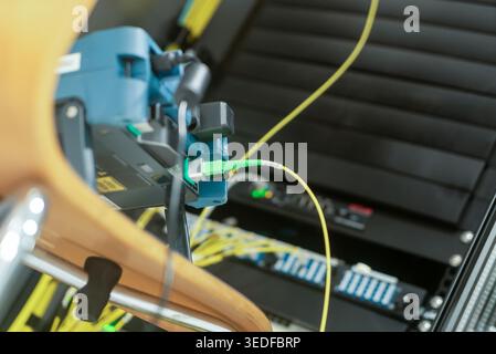 A close-up view of advanced fiber optic installation tools and testing equipment at a modern workstation. This image showcases precision technology fo Stock Photo