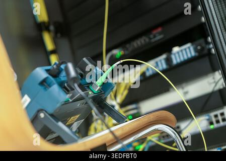 This image showcases high-tech network equipment and cables in a server room, emphasizing connectivity and modern technology in data communication sys Stock Photo