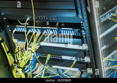 A detailed view of a network rack showcasing cables and connectors, highlighting the organization and infrastructure within a server room. Stock Photo