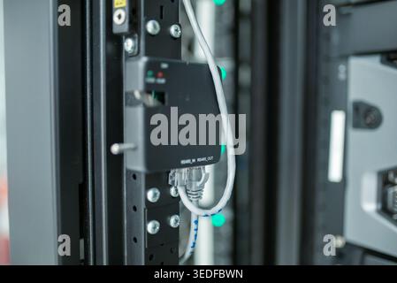 Close-up view of data center rack showcasing networking equipment and cables. Focus on modern technology, ensuring efficient data transmission and con Stock Photo