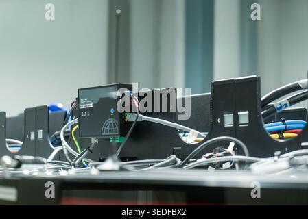 Detailed view of technology interface in a data center showcasing cables, servers, and equipment, emphasizing modern digital communication and network Stock Photo