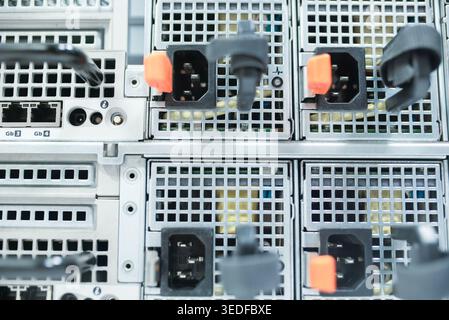 Close-up view of rack-mounted servers showing intricate power connections and networking elements, highlighting modern technology and infrastructure i Stock Photo