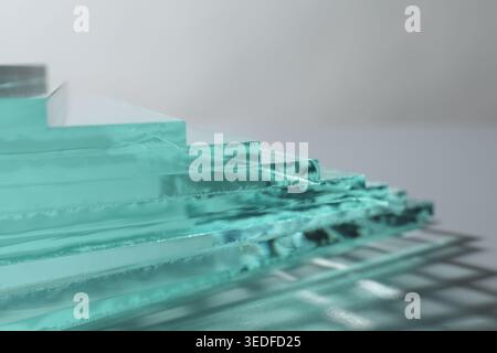Stack of glass sheets on light background, closeup Stock Photo