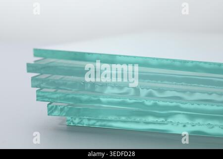 Stack of glass sheets on light background, closeup Stock Photo