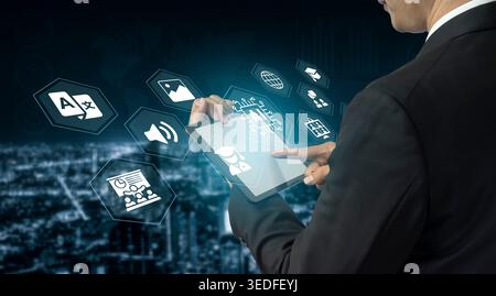 A businessman interacts with a tablet displaying digital icons against a city background, symbolizing technology, innovation, and communication in Stock Photo