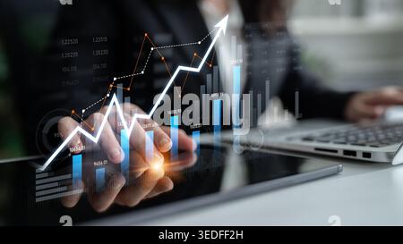 A business professional engages with financial data on a tablet, showcasing a growth chart and analytics in a modern office environment, symbolizing Stock Photo