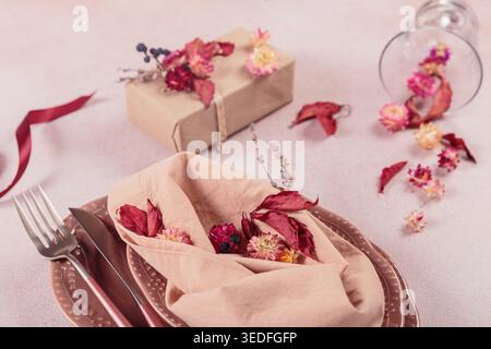 Process of decorating festive autumn table setting with dried flowers Stock Photo