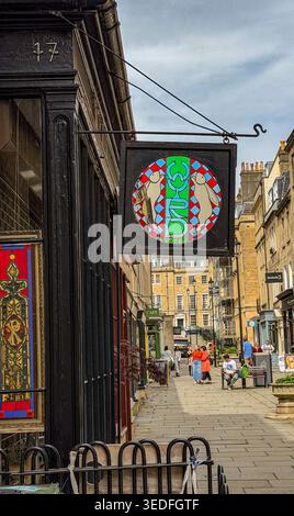 A view of a quaint European street featuring a hanging stained glass shop sign for Wyrd stained glass studio Bath UK Stock Photo