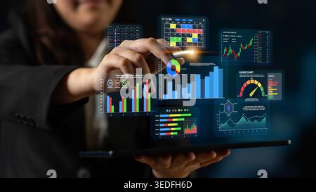 Business professional interacting with digital data visualization on tablet technology in modern workspace for analytics and reporting Quark. Stock Photo