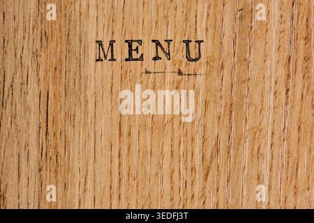 Vintage MENU text stamped on natural light brown wood grain texture background Stock Photo