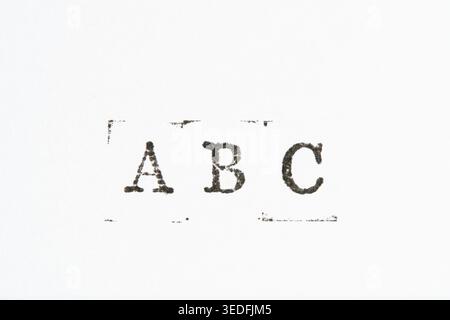 Letters ABC stamped in black ink on white paper. Vintage typewriter or stamp texture Stock Photo