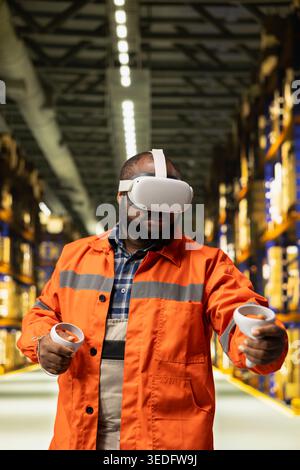 African american staff interacting with VR cyberspace simulation in fulfillment center. AI-powered virtual reality improves tracking accuracy, cargo handling skills and warehouse operations. Stock Photo