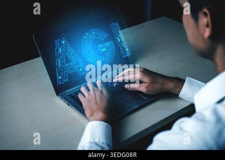 Man Engaged in Technology Work Concept with Laptop Displaying Digital AGI Representation and Futuristic Programmable Elements Haptic. Stock Photo