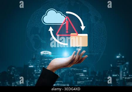 A hand holds a cloud computing symbol with a warning sign and folder, representing modern challenges in data security and management in a digital Stock Photo