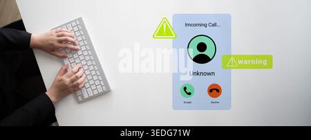 A conceptual image showing an incoming call alert for an unknown caller on a smartphone screen with clear warning signals, while someone types on a Stock Photo