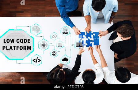 Collaborative Team Working on Low Code Platform with Puzzle Pieces Representing Technology Integration and Innovation in Digital Solutions Quark. Stock Photo