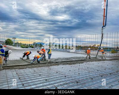 Construction workers pouring concrete slab at a commercial job site two years ago in Orange County, California Stock Photo