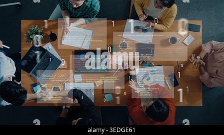 A diverse group of professionals engages in a collaborative brainstorming session, analyzing data and coding on laptops, creating innovative Stock Photo