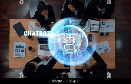 A diverse team of professionals collaborates in a modern office setting, discussing artificial intelligence chatbot tools while analyzing data on Stock Photo