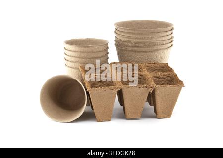 A collection of eco-friendly peat pots and a multi-cell seed starter tray made from recycled paper pulp, perfect for nurturing young plants Stock Photo