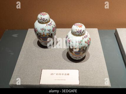 A pair of Qing Dynasty Canton Famille Rose armorial lidded jars at the China Maritime Museum, Shanghai, showcasing export history Stock Photo