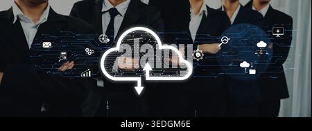 Group of business professionals in suits standing confidently with cloud computing graphics, emphasizing the importance of digital data management and Stock Photo