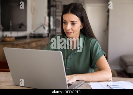 Woman working on project using laptop from homeoffice Stock Photo