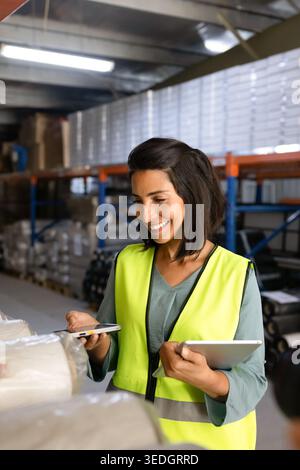 Female worker scanning barcode on package in warehouse Stock Photo