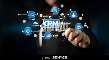 A professional hand interacts with a virtual CRM system, showcasing various digital icons related to customer service, management, and business Stock Photo