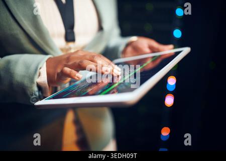 Hands, programmer and woman in server room, tablet for software development and bokeh. Person, datacenter maintenance and employee in workplace, cyber Stock Photo