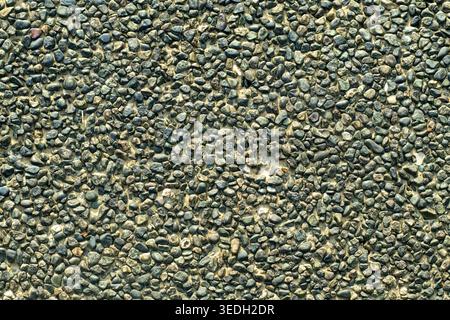 Gray granite surface shows rough, textured patterns Stock Photo