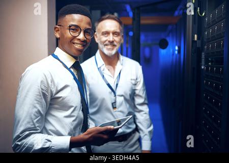 Portrait, storage and tablet with men in server room together for problem solving or solution. App, collaboration and cybersecurity with happy people Stock Photo