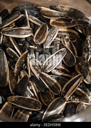 Roasted Sunflower Seeds In Bowl, Closeup Of Salted Shells And Crunchy Texture, Post Snack Remnants Scattered On Wooden Table, Warm Natural Light, Mind Stock Photo