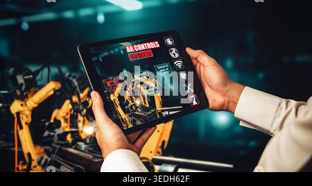 Engineer controls robotic arms by augmented reality industry technology application software. Smart robot machine in future factory working in concept Stock Photo