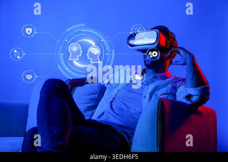 A Young Man Experiencing Virtual Reality with AI Interfaces and Digital Brain Icons in a Futuristic Setting XDMCP Stock Photo