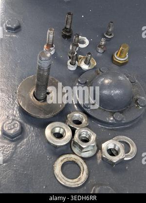 Detailed Closeup Removed Studs And Washers Showing Rusted Threads, Worn Shaft, Tool Marks, Grease Residue, Layered Paint, Macro Diagnostic Perspective Stock Photo