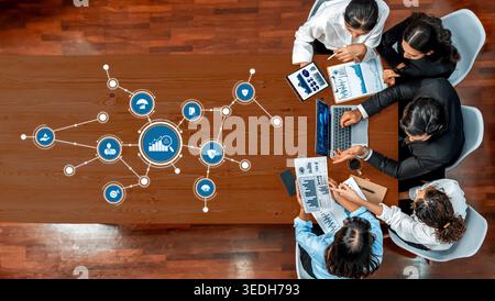 A dynamic business meeting scene featuring professionals engaged in data analysis and strategic planning, surrounded by digital icons representing Stock Photo