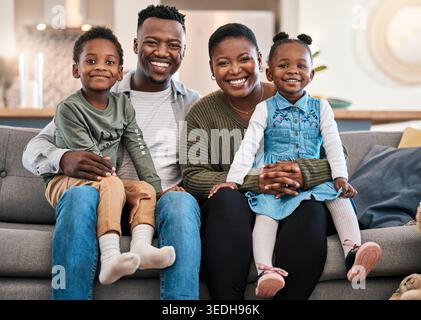 Happy, parents and bonding with children on couch, family and laughing together on weekend in house. Portrait, mom and dad with kids, affection and Stock Photo