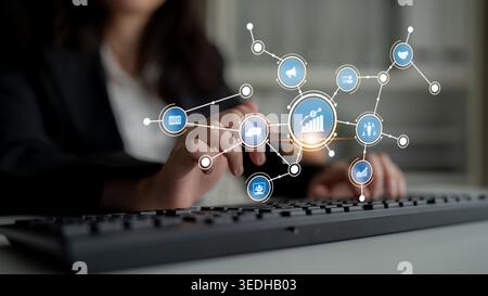A businesswoman interacts with a keyboard while digital icons and graphs appear, symbolizing data analytics, technology innovation, and growth Stock Photo