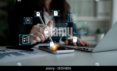 Person Working on Digital Security Concepts with Laptop and Smartphone, Showing Lock Icon, Password, Username, and Data Protection Graphics on Screen Stock Photo