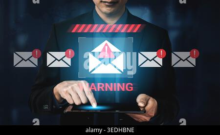 A businessman examines a cybersecurity alert on a tablet, highlighting email risks and notifications to emphasize the importance of digital security Stock Photo