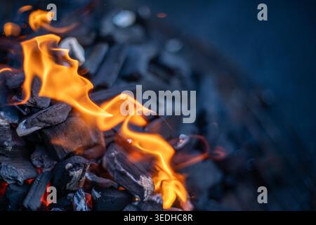 Igniting Charcoal with Flames, Close Up of Barbecue Fire, Outdoor Cooking Concept with copy space Stock Photo