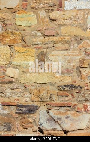 Ancient composite stone wall with bricks as background Stock Photo