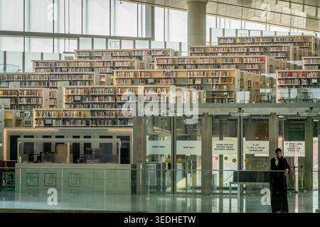 Qatar National Library interior in Doha, Qatar, modern architecture with bookshelves, stairs and bright reading space. Stock Photo