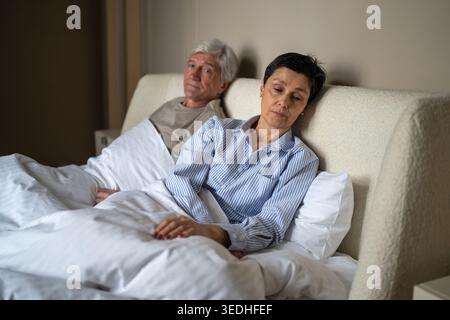 Loneliness and intimacy problems at older age, silent senior woman avoiding contact with partner. Stock Photo