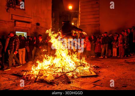 A man leaps over a street bonfire during Novruz celebrations in Icheri Sheher, Baku, Azerbaijan. Stock Photo