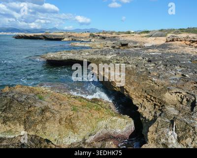 Rocky coastline at Cala Blava Mallorca with clear sea water and wide view over the Bay of Palma. Copyspace. Stock Photo